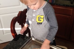 Making his own personal pizza :)